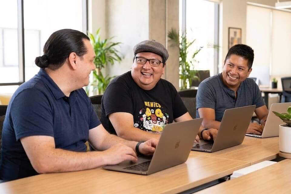 weKnow LATAM development team collaborating in a modern office